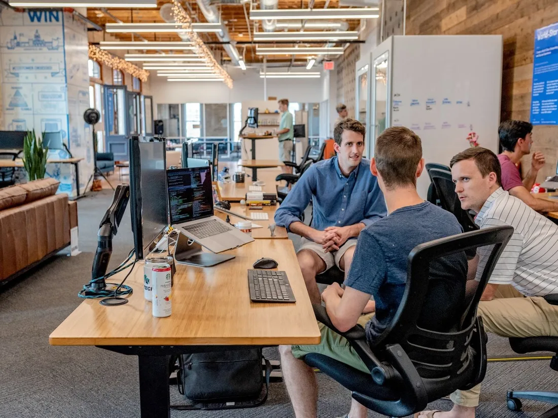 A team working together at a long desk in an open-plan office