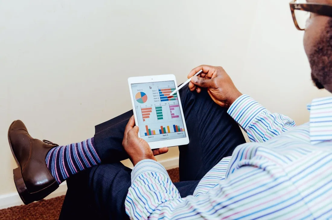A manager reviewing business performance charts on a tablet